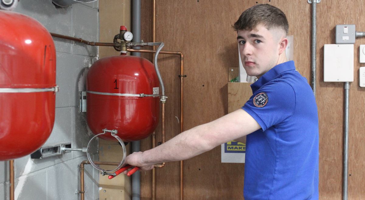 Conor McMullan, working with plumbing equipment 